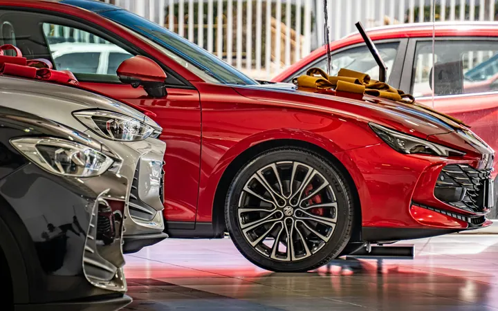 New cars lined up inside a dealership showroom