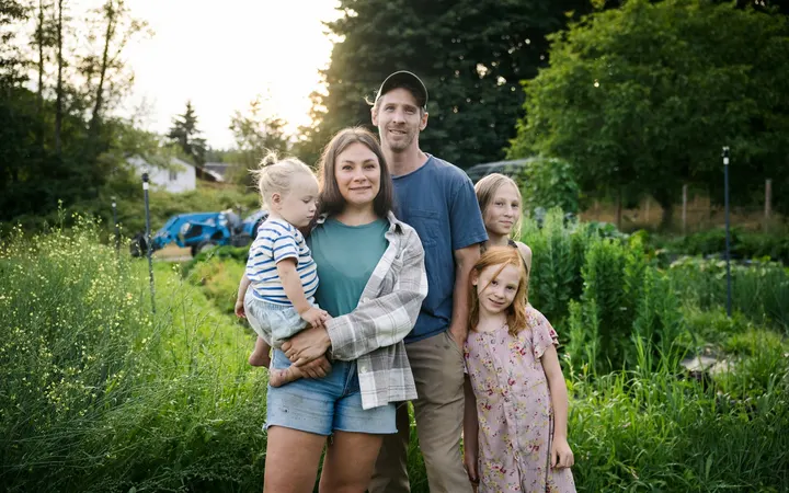 Family with two children standing in a garden
