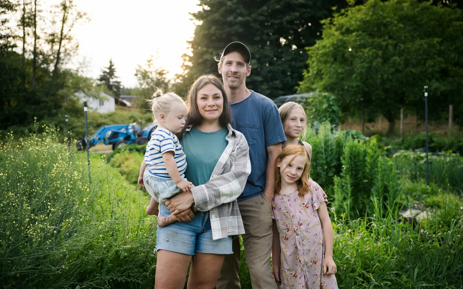 Family with two children standing in a garden