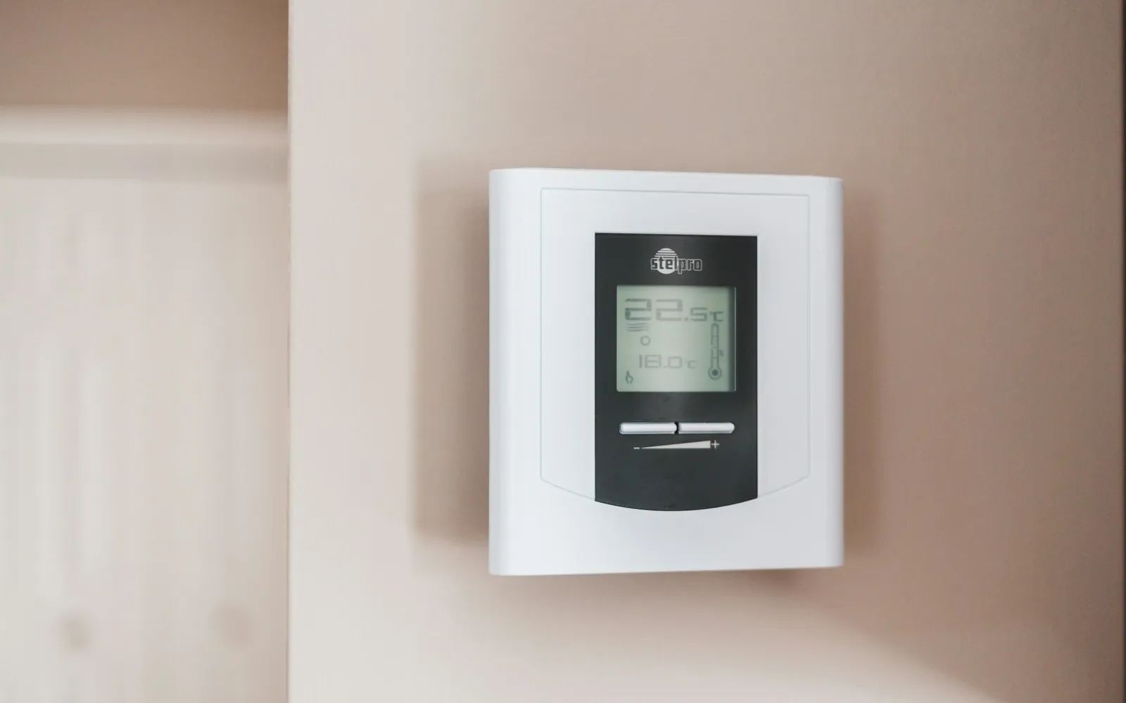 Home heating thermostat on a wall